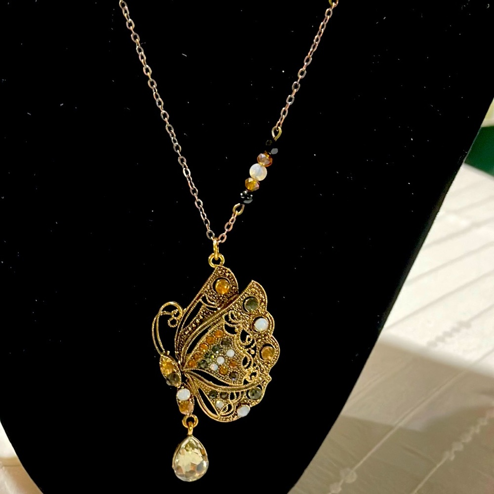 Beautiful butterfly pendant with beaded accents.